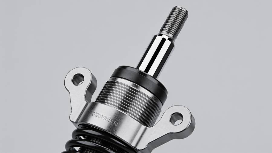 Related Image: Close-up of a new forklift shock absorber showing its piston, cylinder, and mounting points, isolated on a clean background